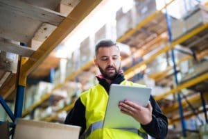 warehouse manager assessing clipboard